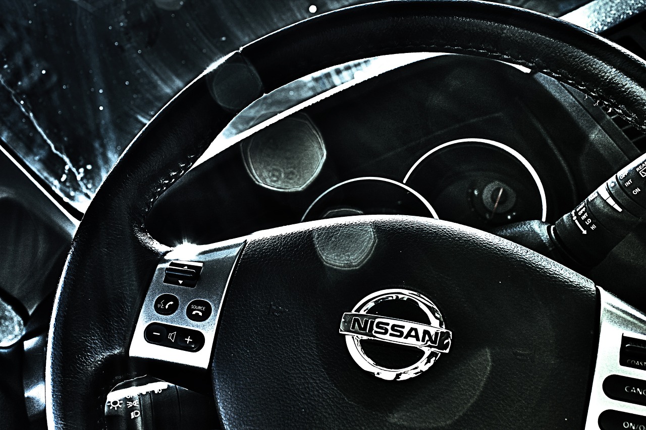 A Nissan steering wheel and driver dashboard